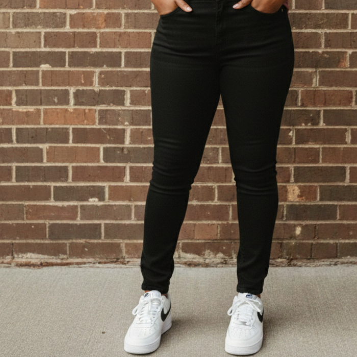 Aisha wearing a black Rockstar denim and blue and white sneakers