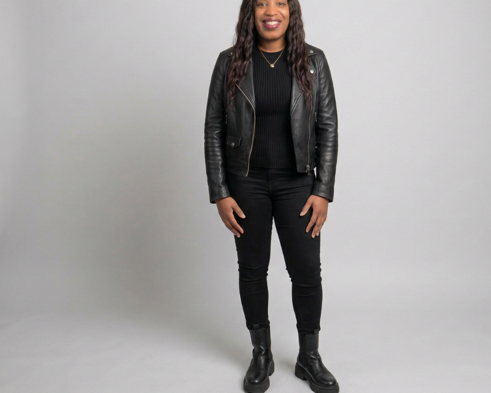 An image of a model wearing a black leather moto jacket, black sweater, black skinny jeans, and black chunky boots