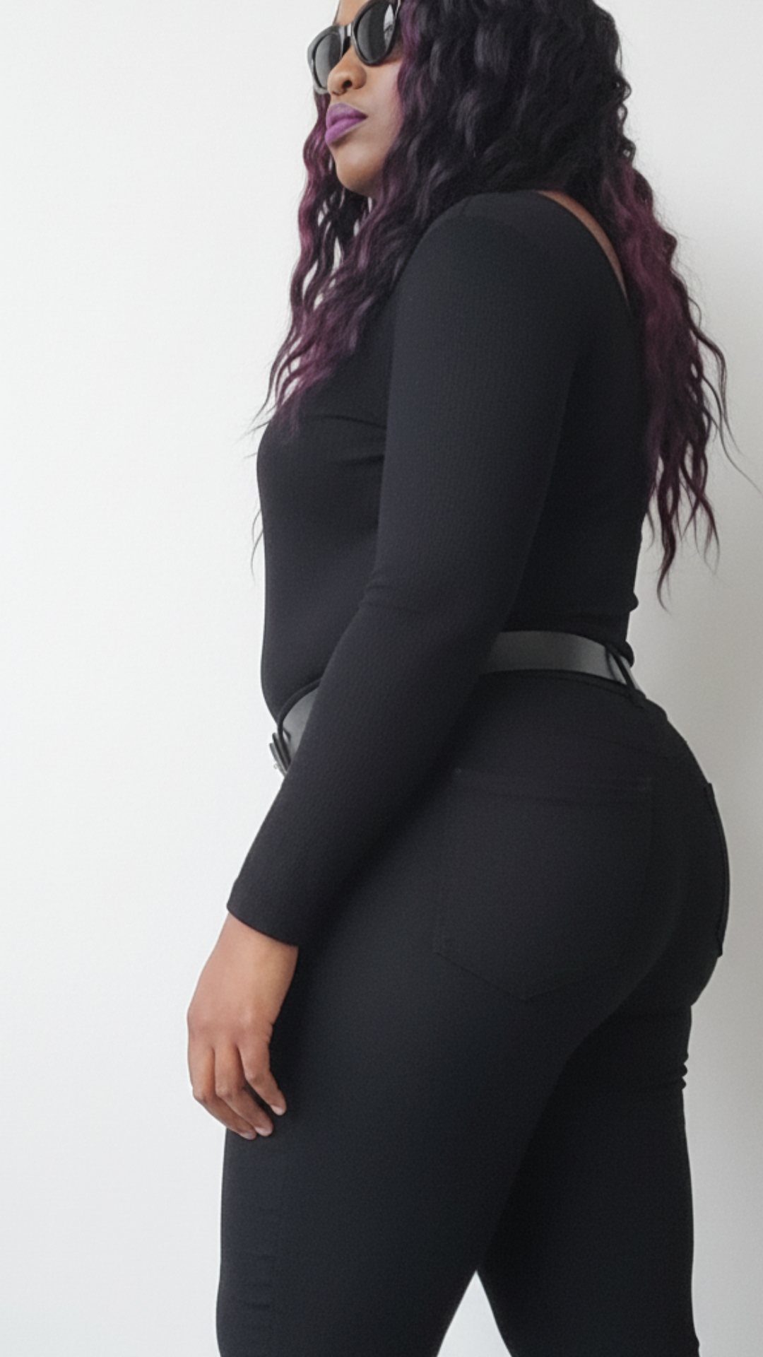 Model wearing a black V-Cut top, black denim