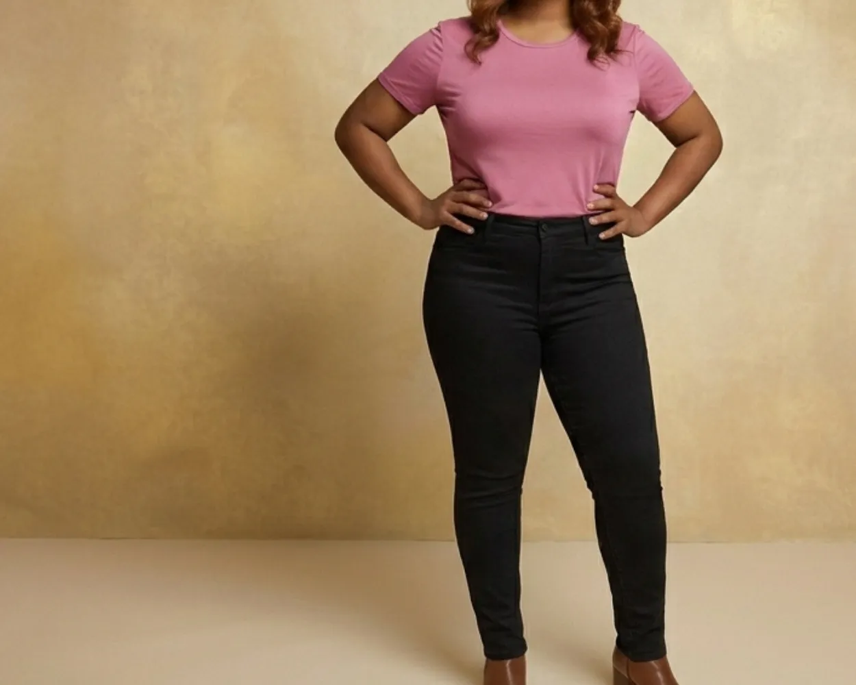 Stylish African American model wearing a pink tee, black denim