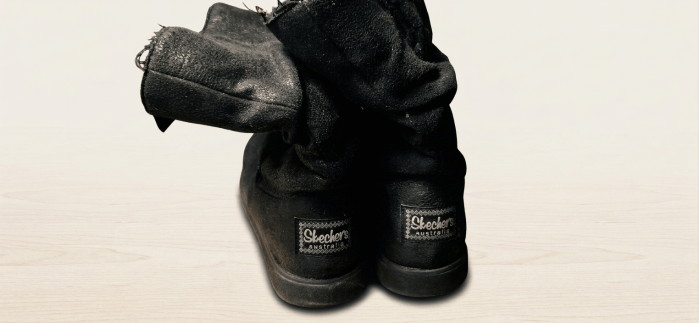 A pair of black Skecher boots.
